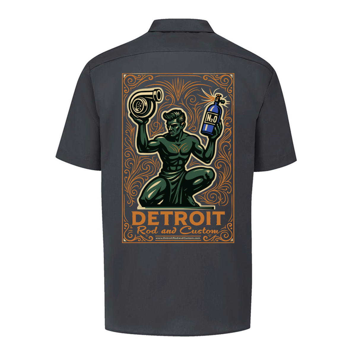 Back of a dark charcoal Dickies work shirt with a large print of the green kneeling statue holding a turbo and a bottle, over an orange DETROIT Rod and Custom panel.