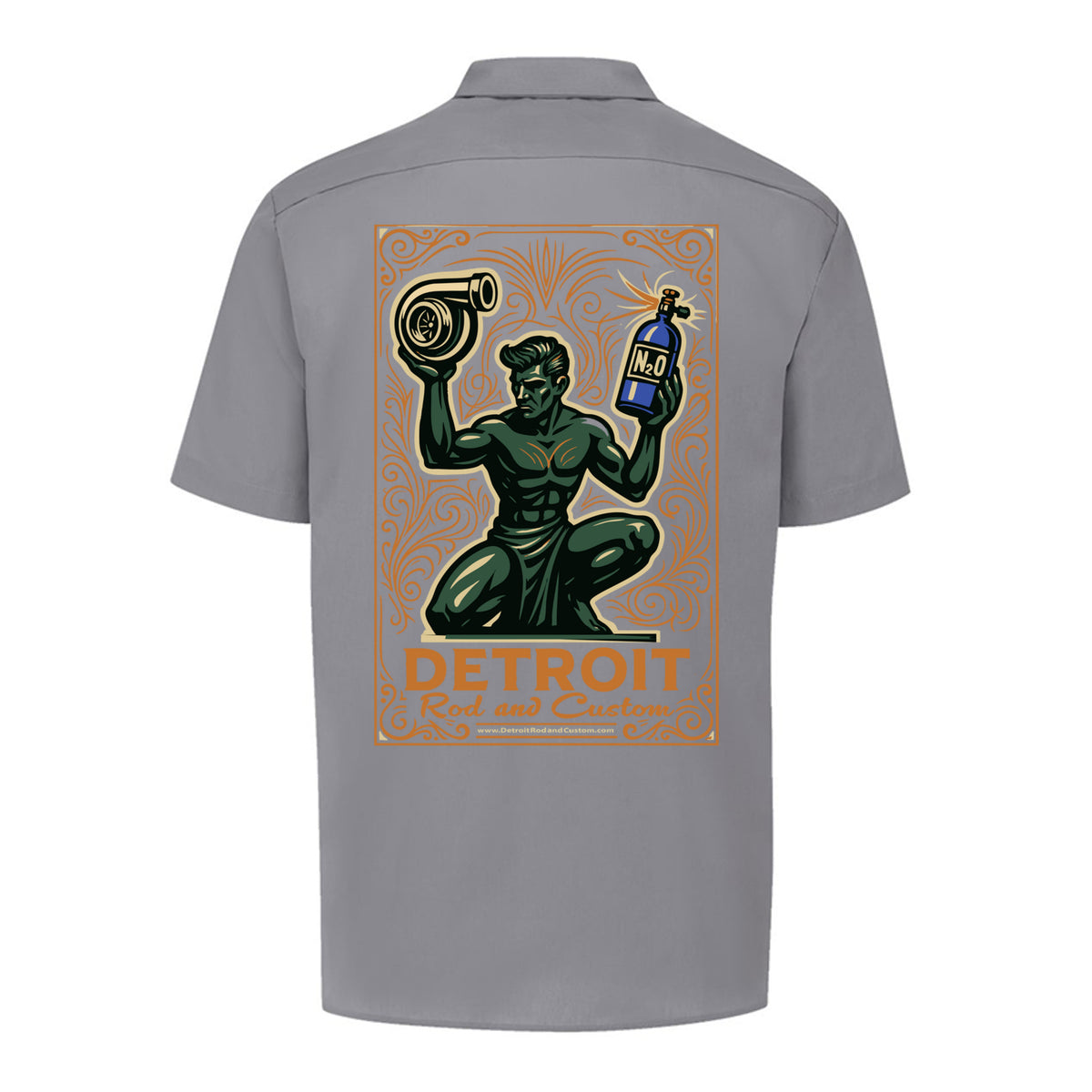 Back of a graphite grey Dickies work shirt with a large print of the green kneeling statue holding a turbo and a bottle, over an orange DETROIT Rod and Custom panel.