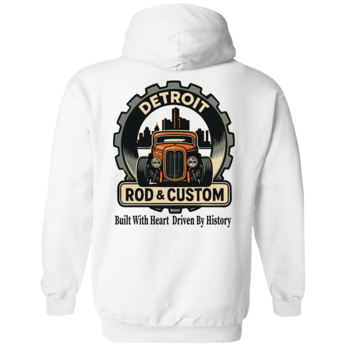 Back of a white hoodie with a large round gear badge: "DETROIT" arched at top, an orange chopped hot rod coupe in front of a black Detroit skyline, a "ROD & CUSTOM" banner, and "Built With Heart Driven By History" in script below.