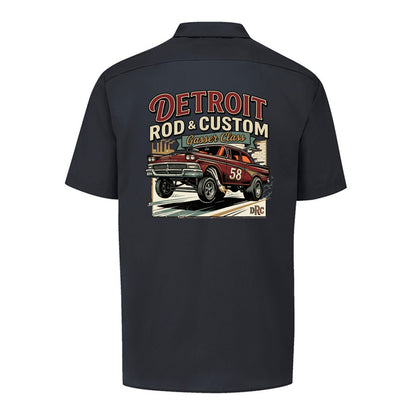 Back of a black Dickies short-sleeve work shirt with a burgundy #58 Galaxie gasser launching nose-up under a red DETROIT ROD & CUSTOM banner.